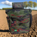 Camo metal detecting finds pouch with a field in the background