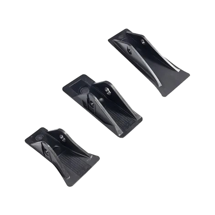 Three black plastic repair lugs on a white background